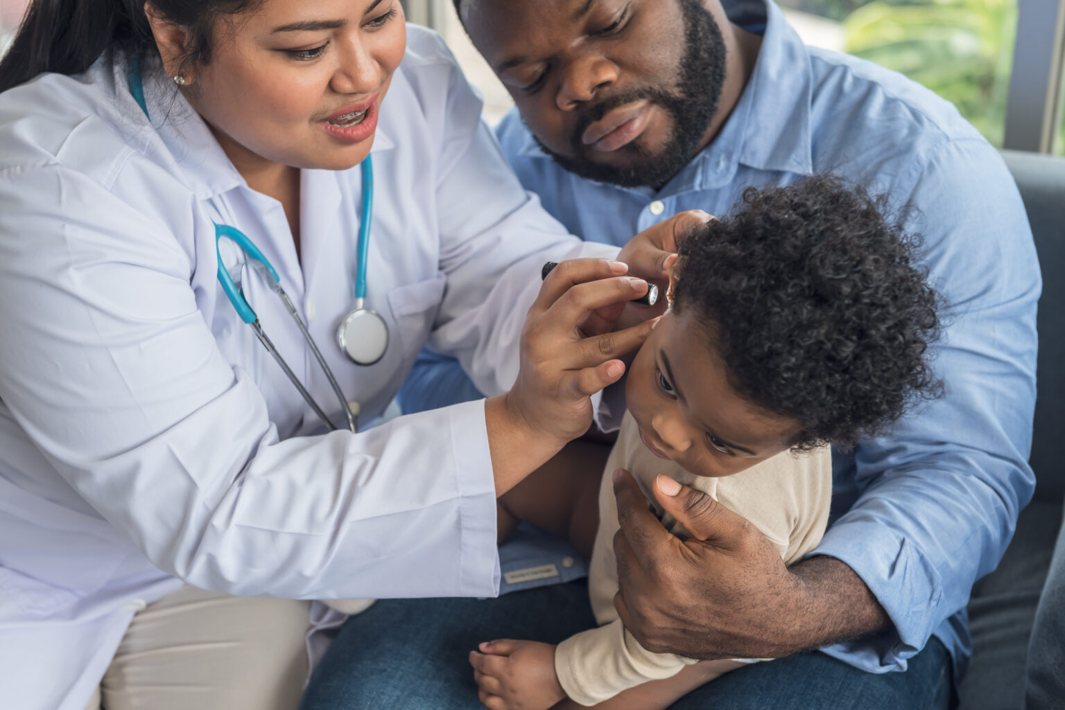 baby with doctor checking ears